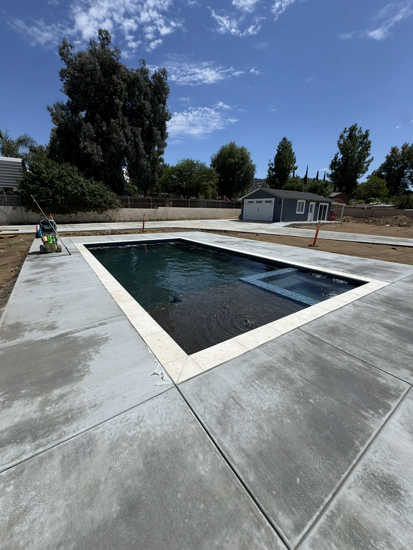 Newly built rectangular swimming pool with clean concrete decking, designed and constructed by Innovation Landscaping & Pools Inc., serving Moreno Valley and surrounding areas.