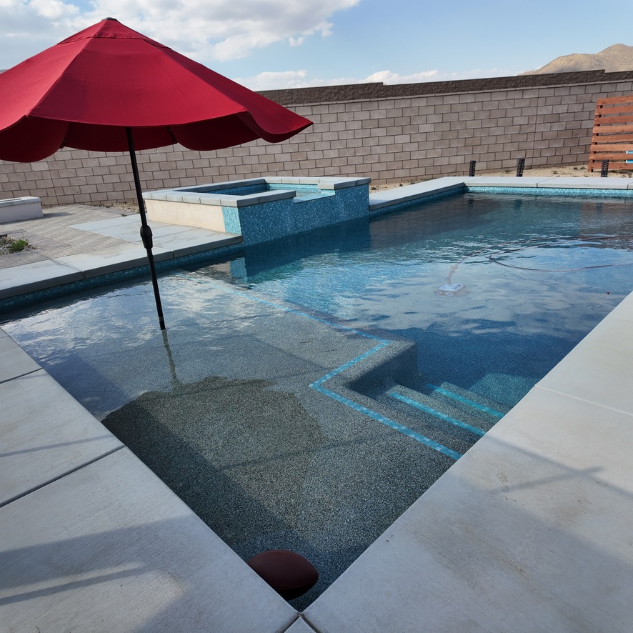 swimming pool with dark interior finish and raised spa